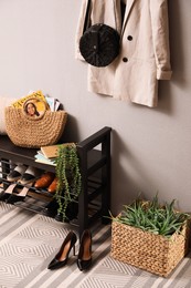 Photo of Hallway interior with stylish furniture, clothes and accessories