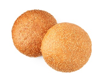 Photo of Fresh hamburger buns with sesame seeds isolated on white, top view