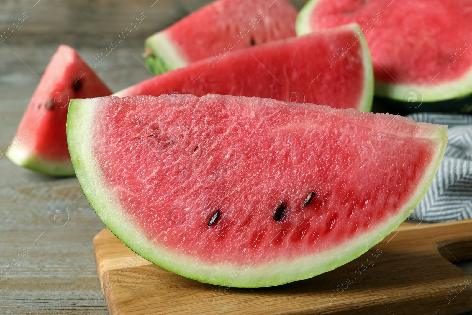 Photo of Delicious fresh watermelon slices on wooden table, closeup