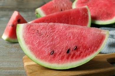 Photo of Delicious fresh watermelon slices on wooden table, closeup