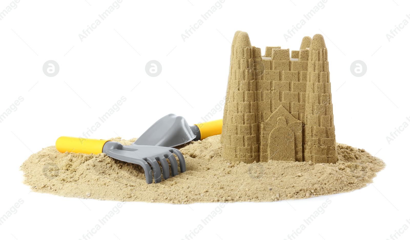 Photo of Pile of sand with beautiful castle and plastic toys isolated on white