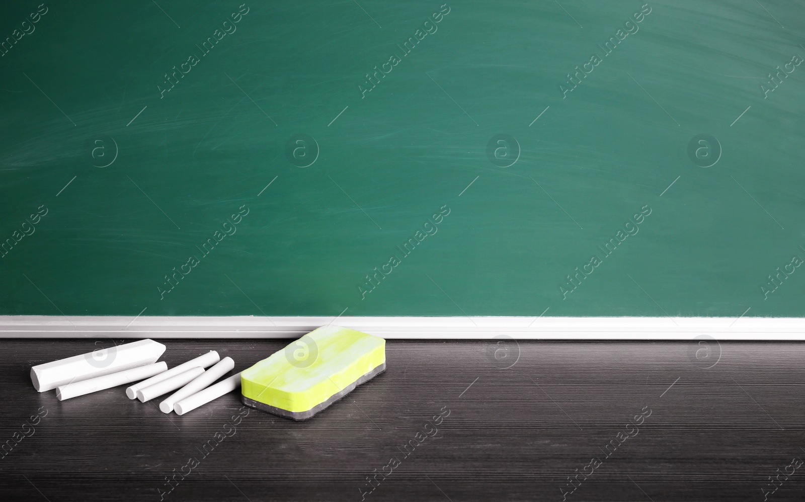 Photo of Chalk and duster on table in classroom