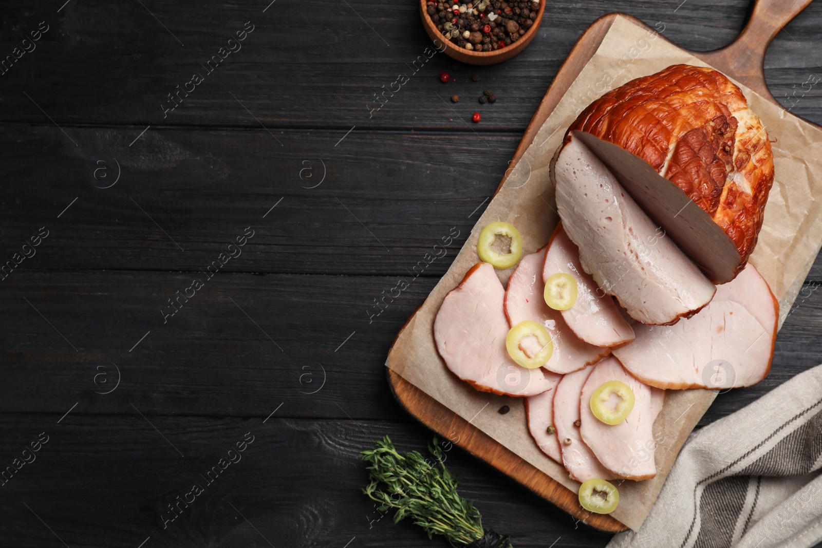 Photo of Delicious cut ham with spices served on black wooden table, flat lay. Space for text