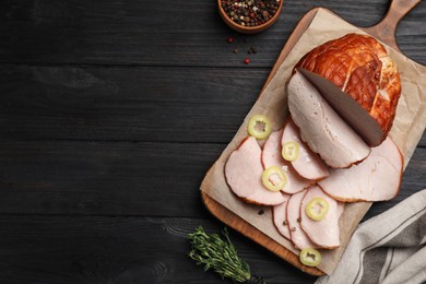 Photo of Delicious cut ham with spices served on black wooden table, flat lay. Space for text