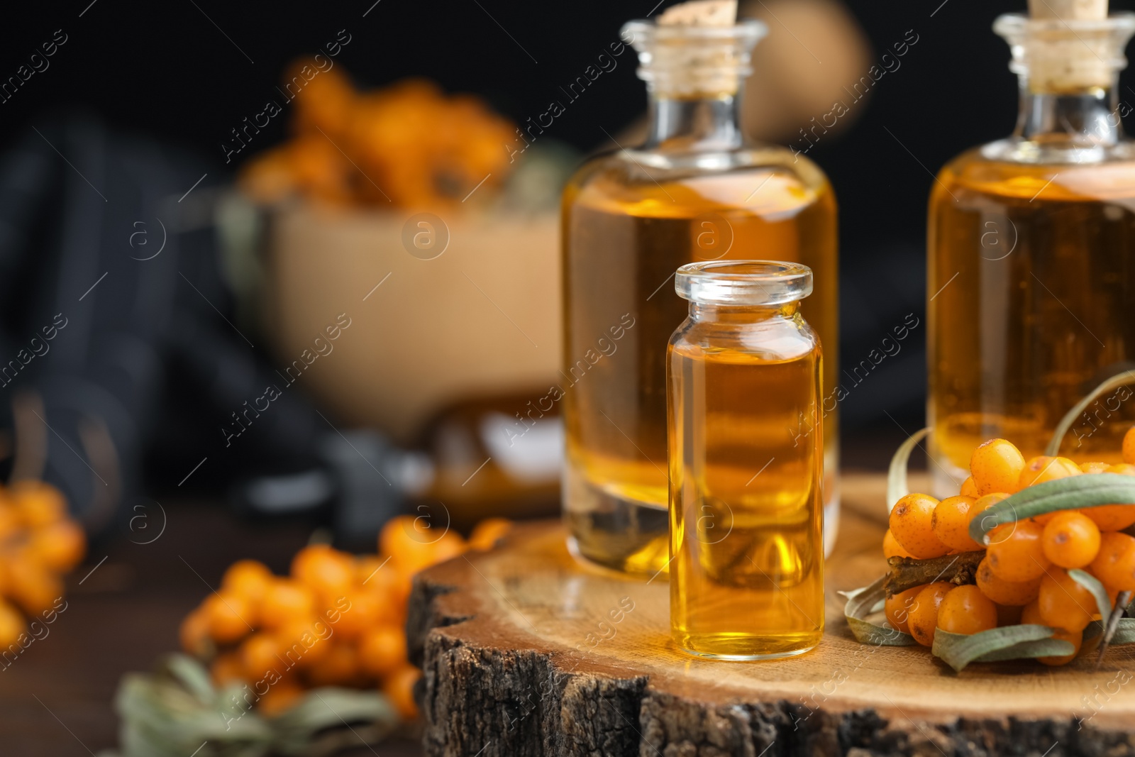 Photo of Natural sea buckthorn oil in bottles. Space for text