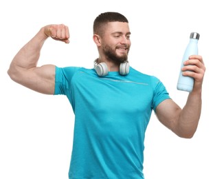 Handsome man with thermo bottle and headphones on white background