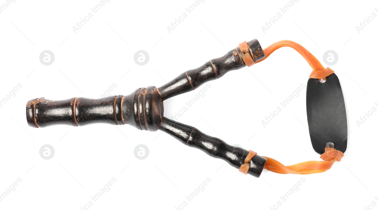 Photo of Black wooden slingshot with leather pouch on white background, top view
