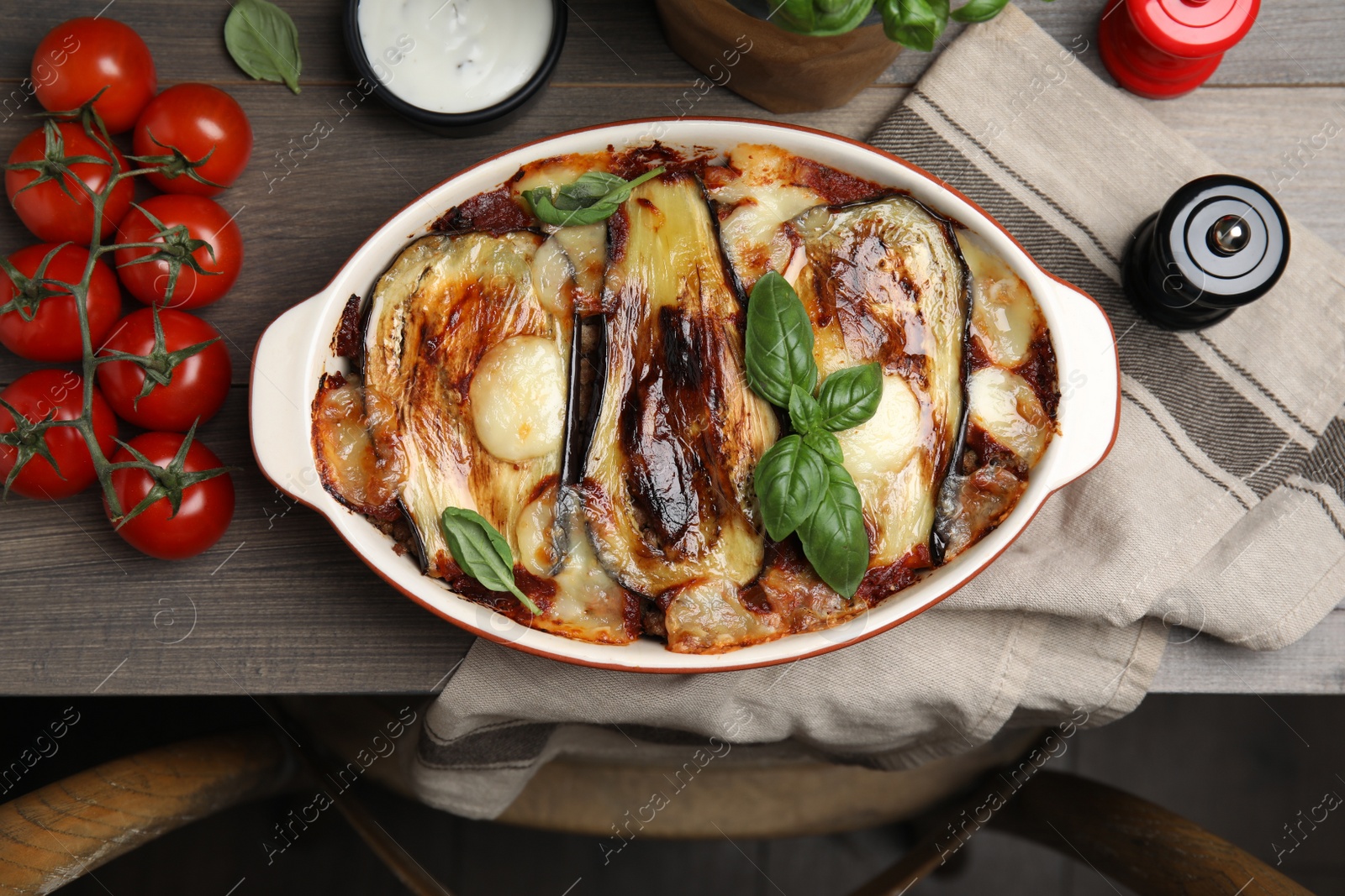 Photo of Delicious eggplant lasagna in baking dish on wooden table, top view