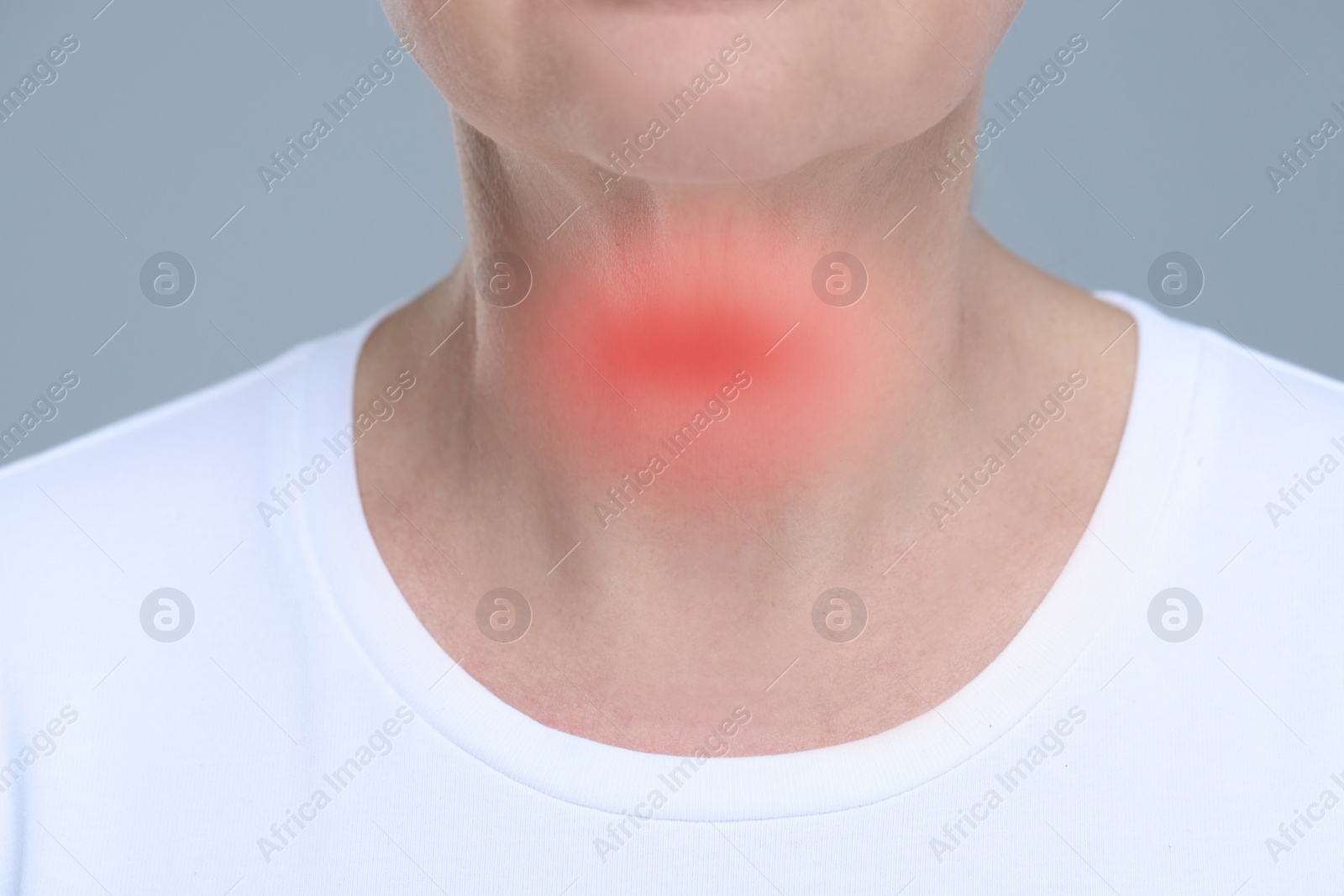 Image of Endocrine system. Woman suffering from pain in thyroid gland on grey background, closeup