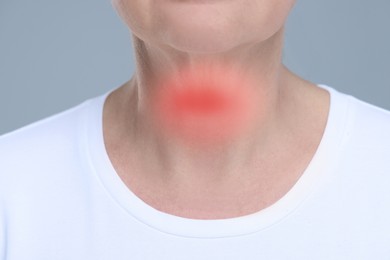 Image of Endocrine system. Woman suffering from pain in thyroid gland on grey background, closeup