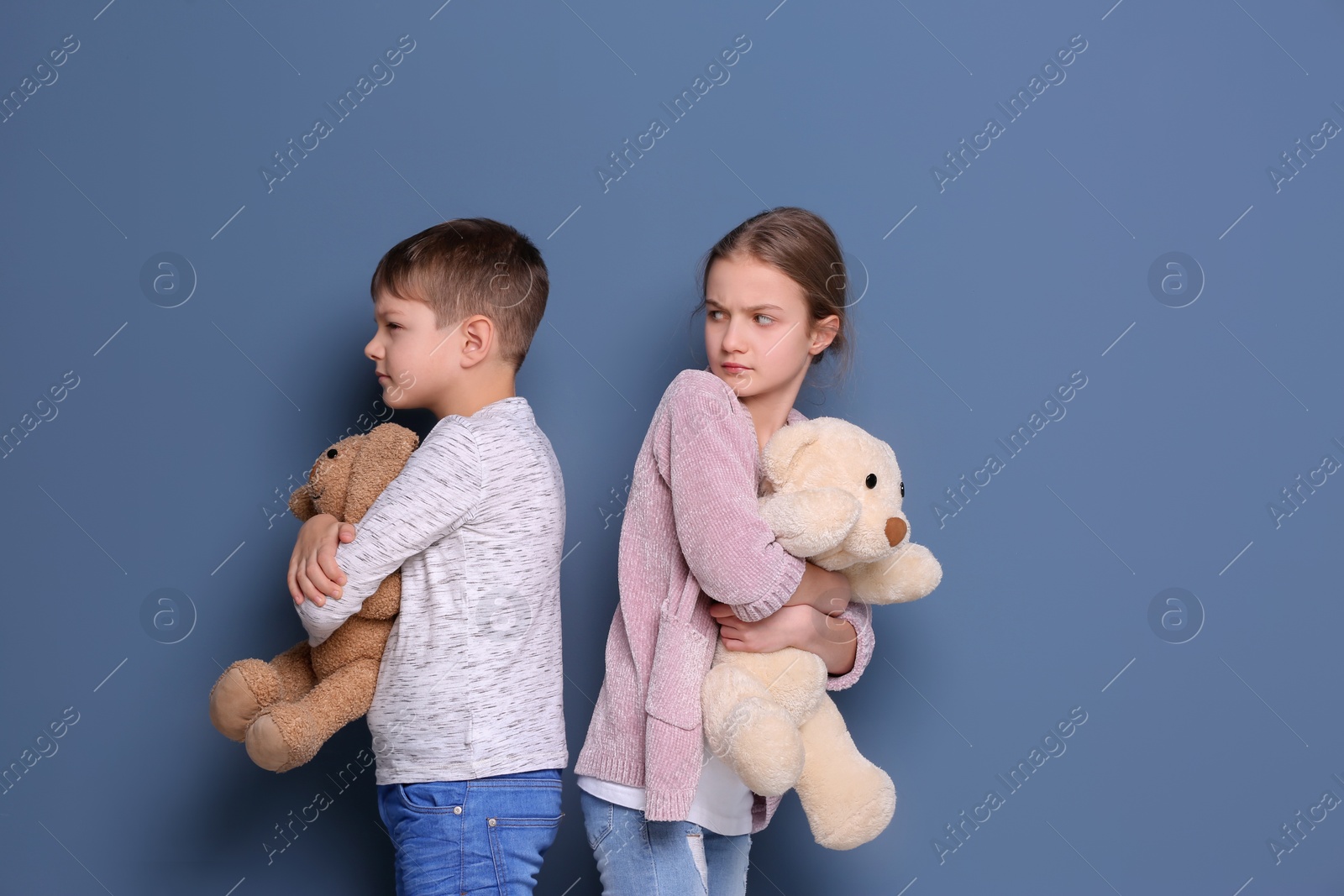 Photo of Brother arguing with sister on color background