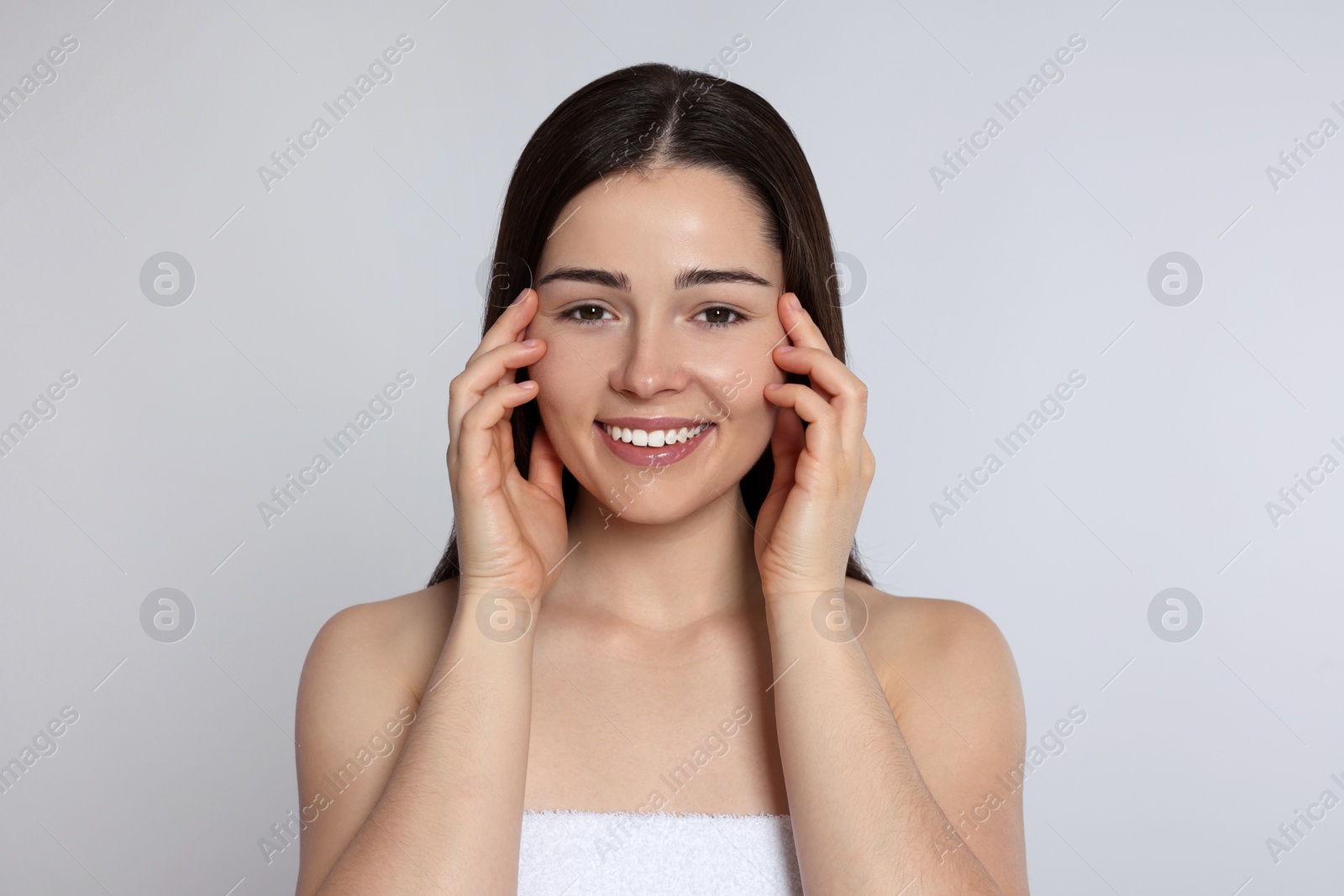 Photo of Portrait of attractive young woman on light grey background. Spa treatment