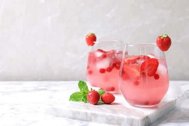 Glasses of natural lemonade with berries on table