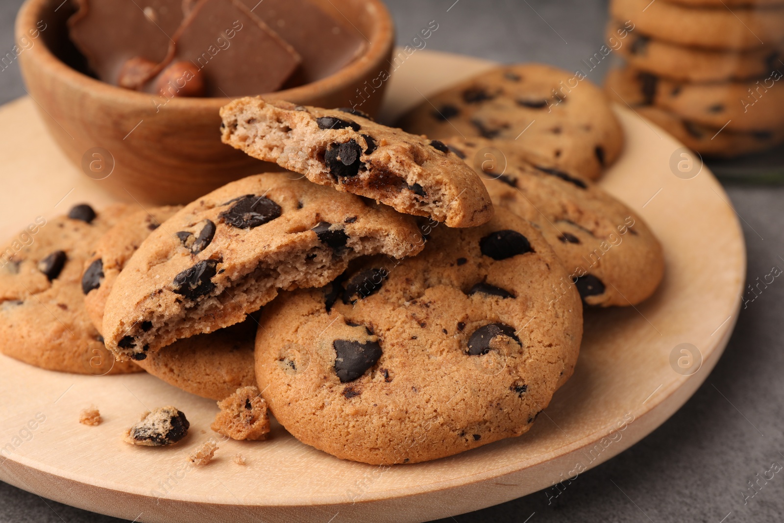 Photo of Delicious chocolate chip cookies on grey table, closeup