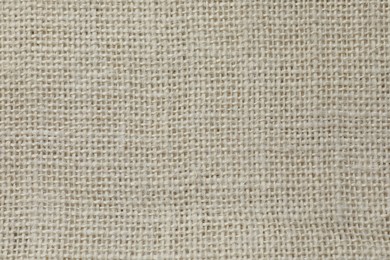 Texture of beige fabric as background, top view