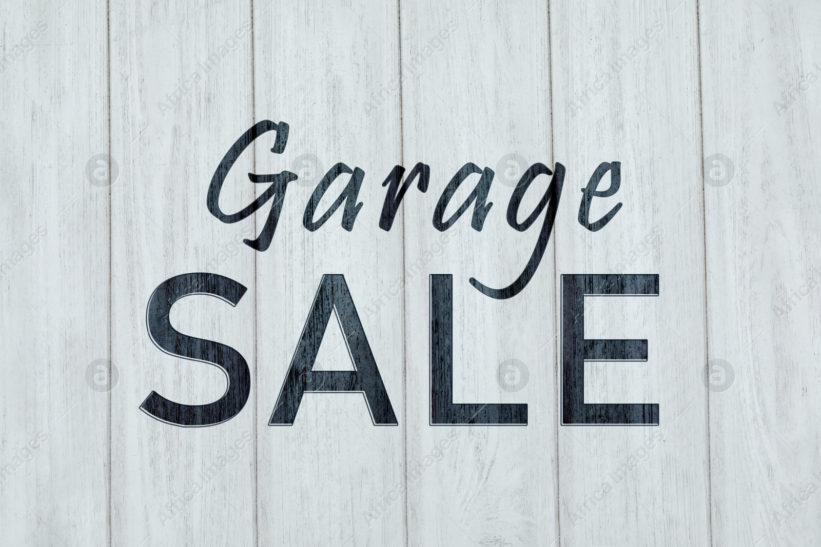 Image of Words Garage Sale on white wooden surface, top view