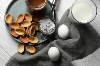 Photo of Ingredients for delicious walnut shaped cookies with condensed milk on white wooden table, flat lay