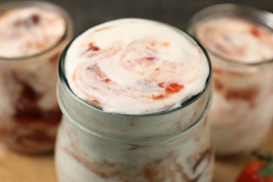 Tasty yoghurt with jam on table, closeup