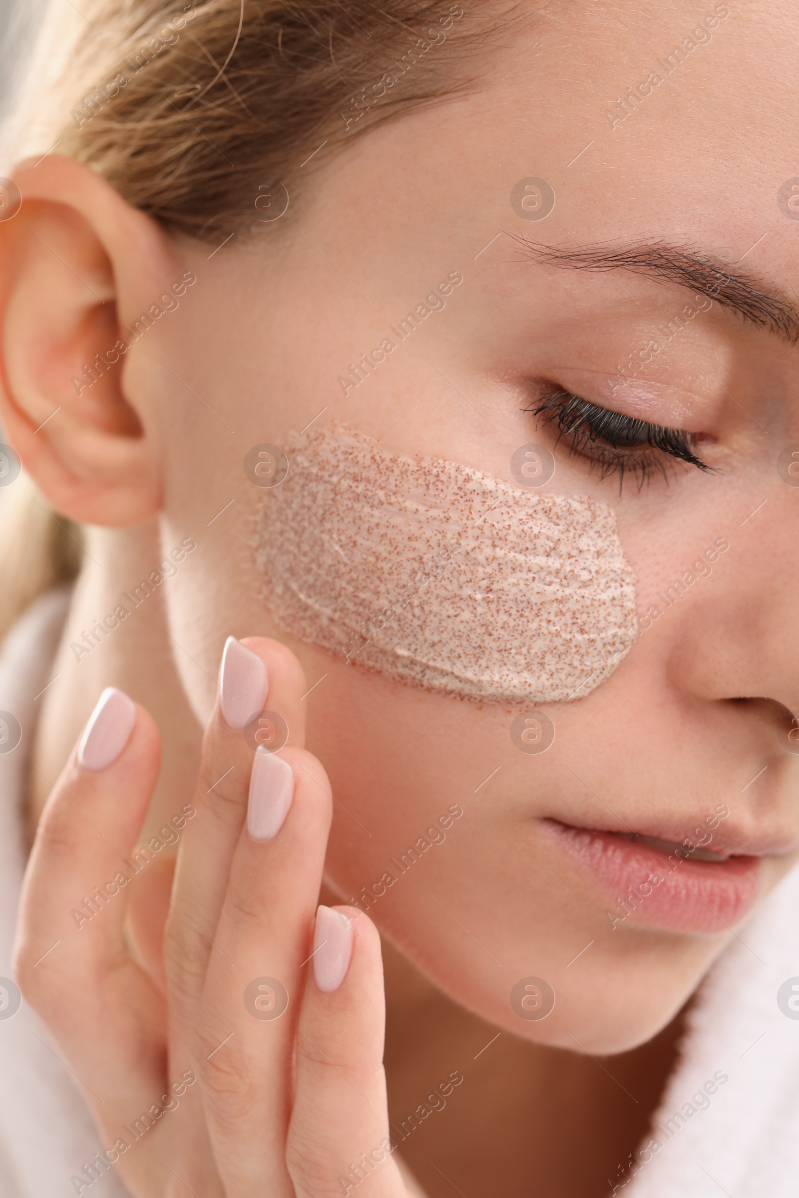 Photo of Woman with cosmetic product on her face, closeup. Spa treatments