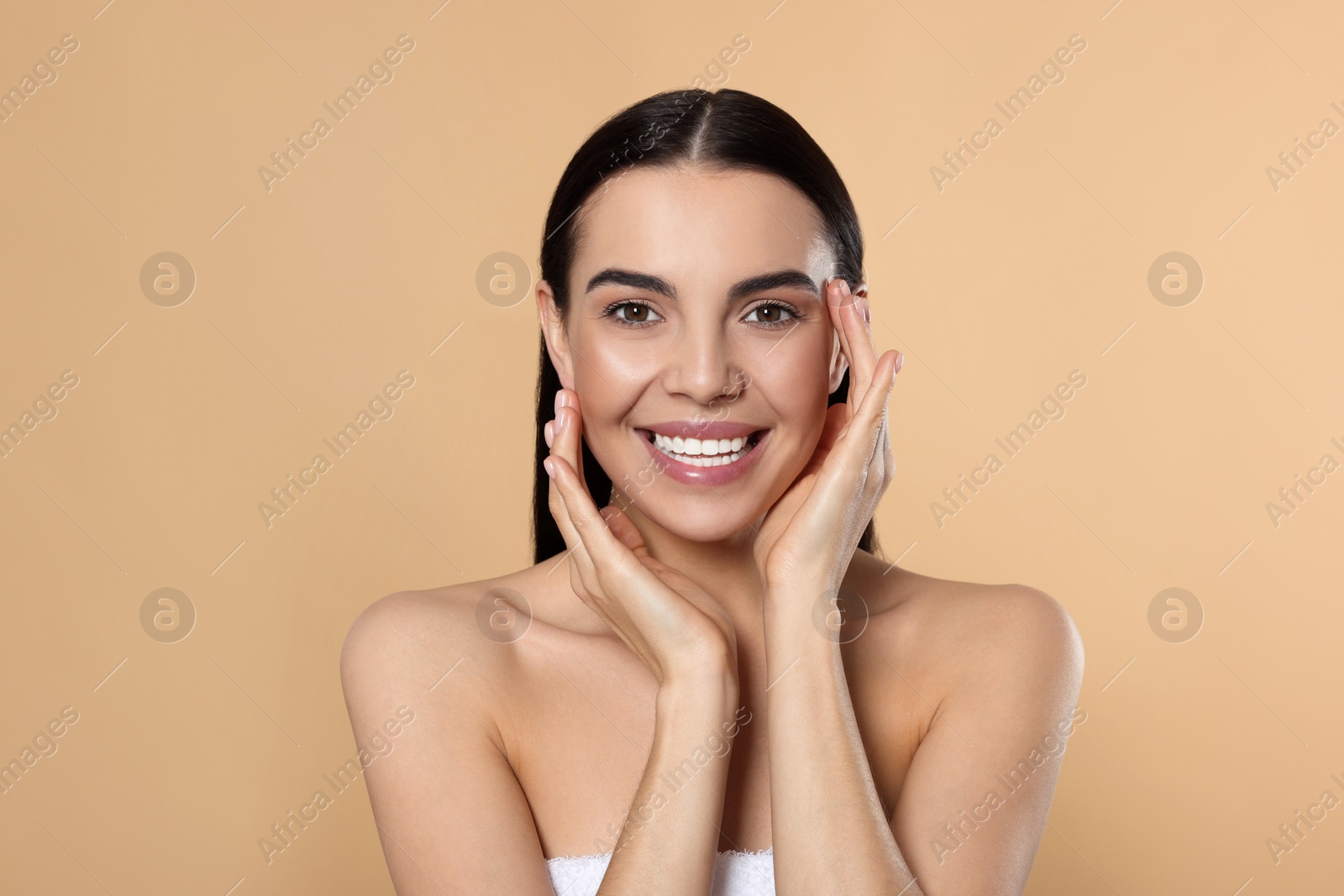 Photo of Portrait of attractive young woman on beige background. Spa treatment