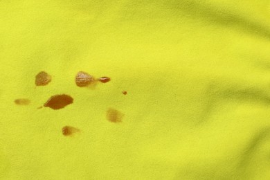Photo of Stains of jam on green fabric, top view