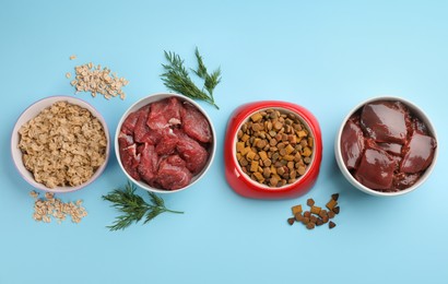 Pet food and natural ingredients on light blue background, flat lay