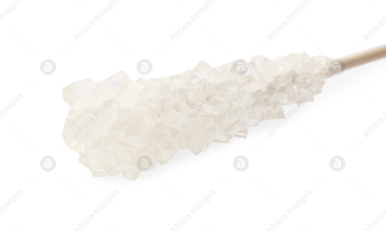 Photo of Wooden stick with sugar crystals isolated on white, closeup. Tasty rock candy