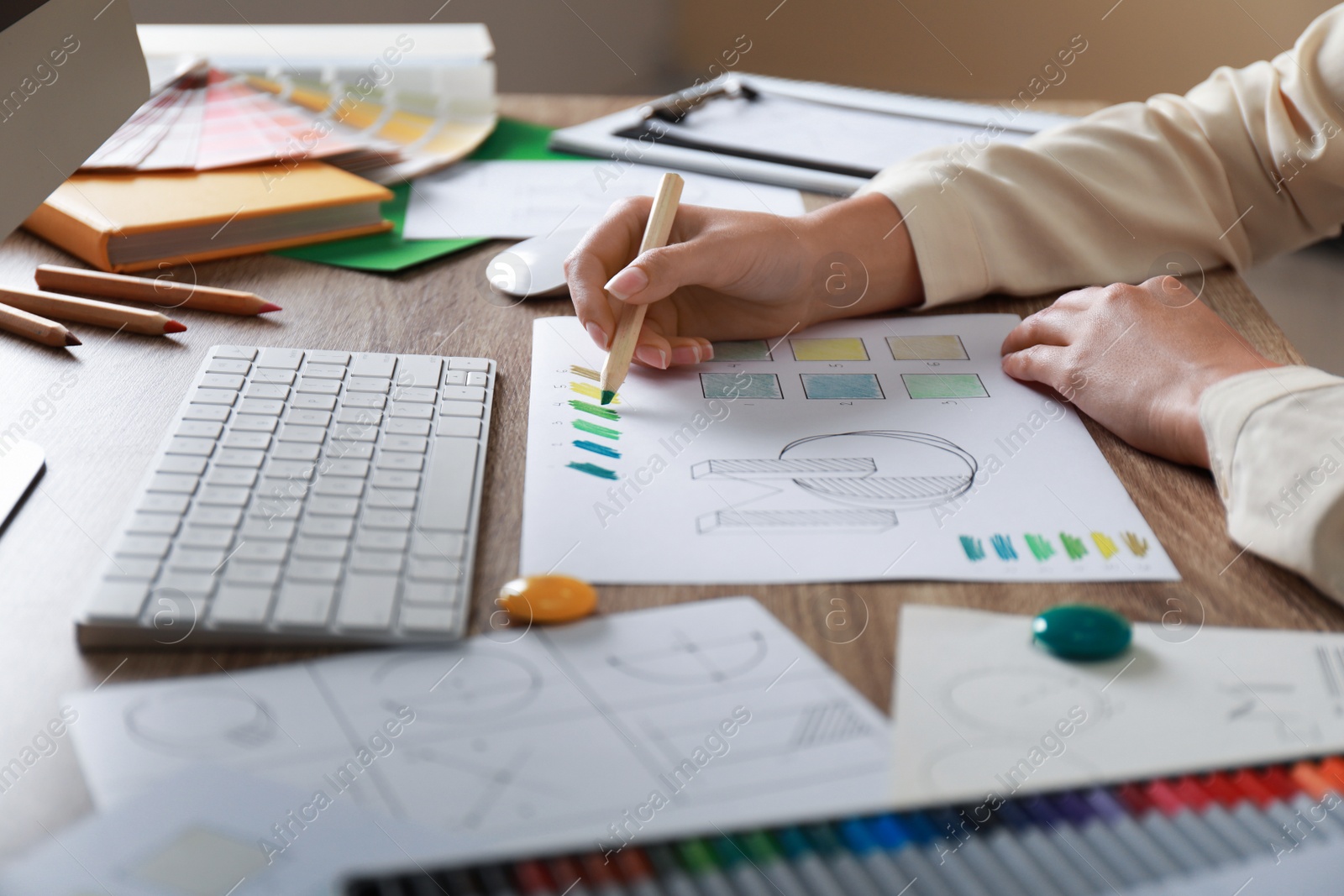 Photo of Female designer working at wooden table, closeup