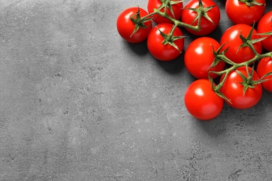 Photo of Fresh cherry tomatoes on stone background, flat lay. Space for text