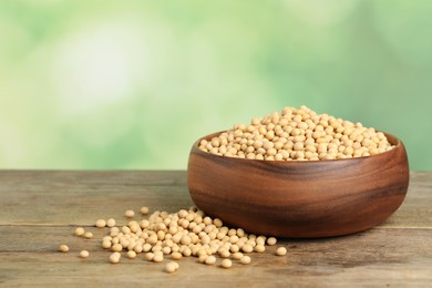 Natural soy beans on wooden table. Space for text