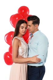 Photo of Beautiful couple with heart shaped balloons on white background