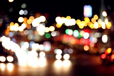 Photo of Blurred view of night city street with bokeh effect