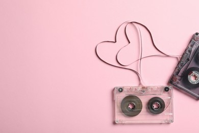 Photo of Music cassettes and hearts made of tape on pink background, flat lay with space for text. Listening love songs