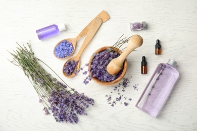 Flat lay composition with lavender flowers and natural cosmetic on wooden background