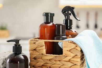 Photo of Different cleaning supplies in wicker basket, closeup