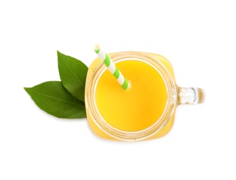 Photo of Tasty orange juice in mason jar and green citrus leaves isolated on white, top view