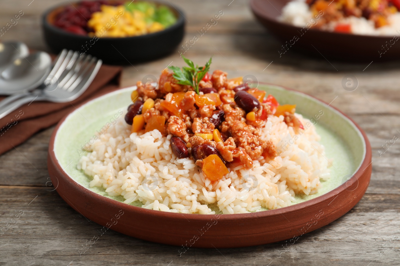 Photo of Chili con carne served with rice on table