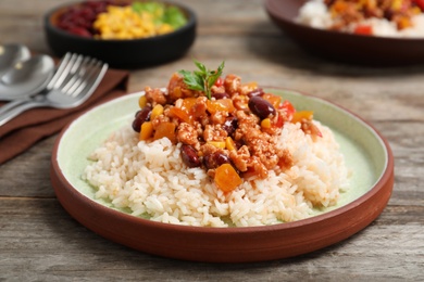 Chili con carne served with rice on table