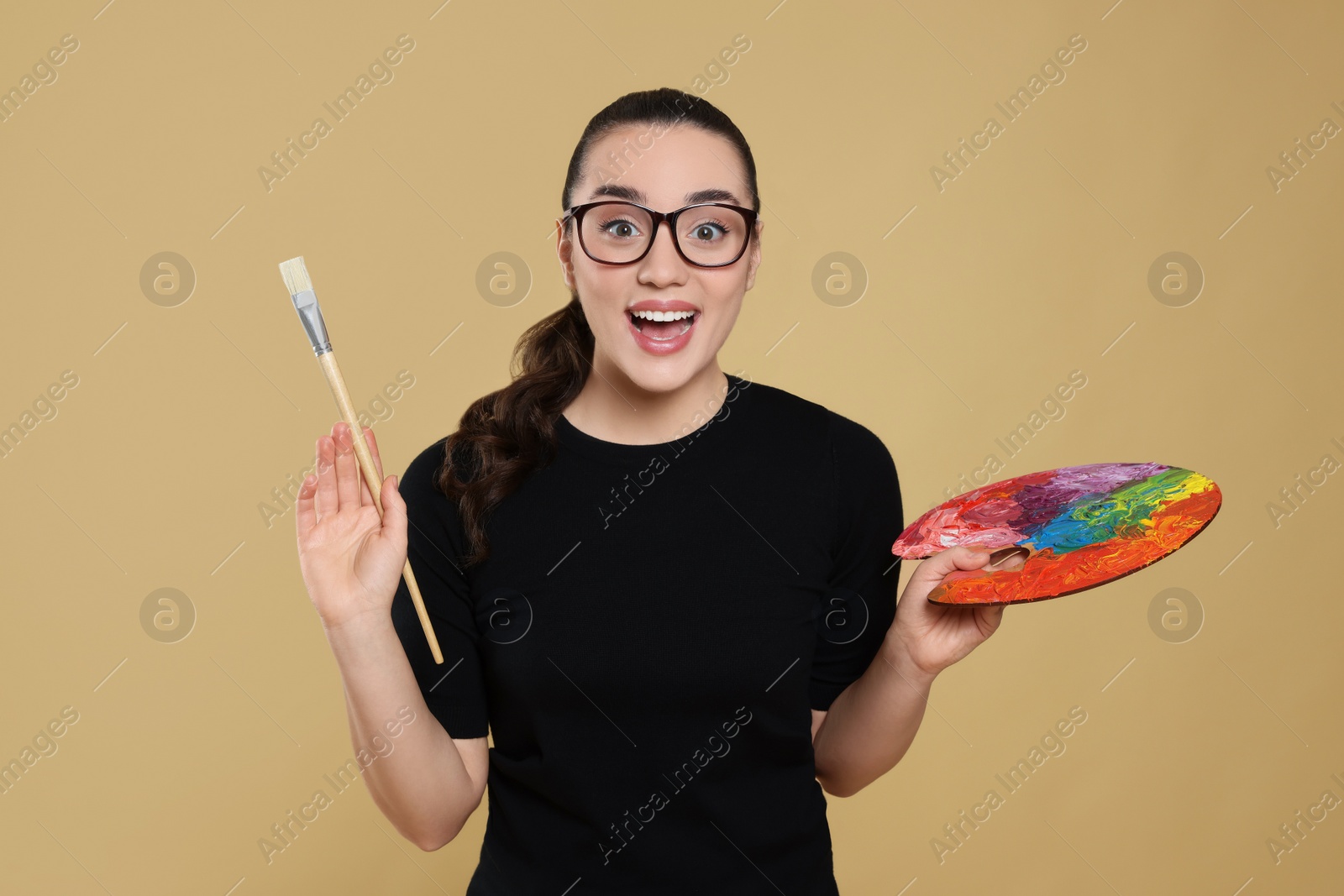 Photo of Woman with painting tools on beige background. Young artist