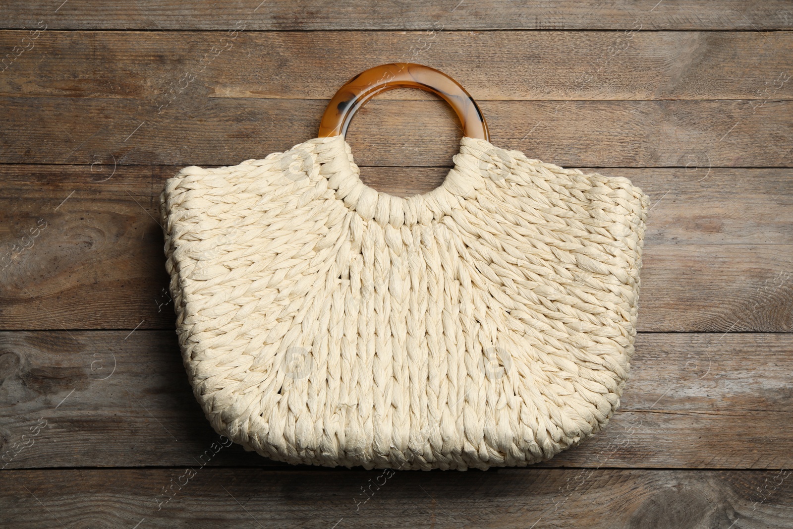 Photo of Stylish woman's bag on wooden background, top view