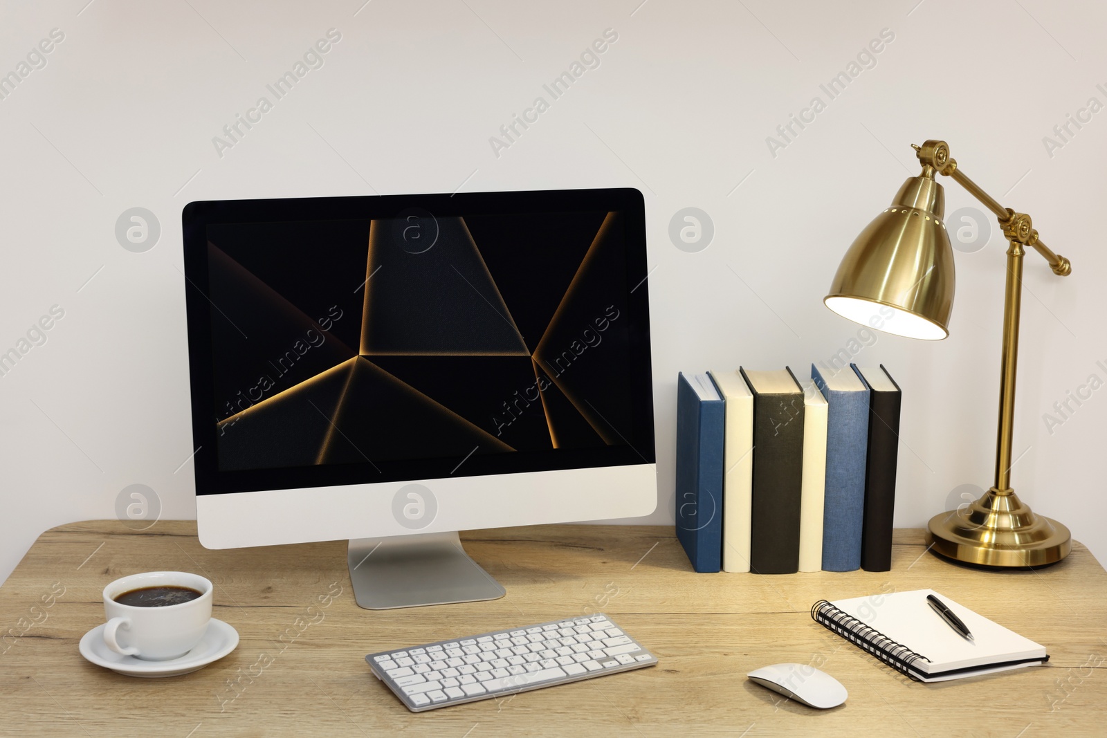 Photo of Cozy workspace with computer on wooden desk at home