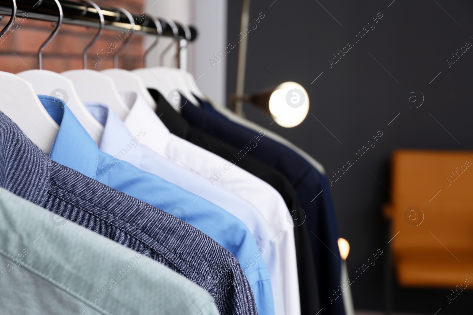 Photo of Wardrobe rack with stylish clothes indoors, closeup. Space for text