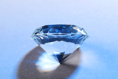 Photo of Beautiful dazzling diamond on light background, closeup