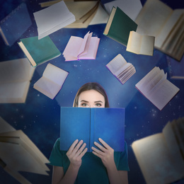 Young woman reading and flying books on color background