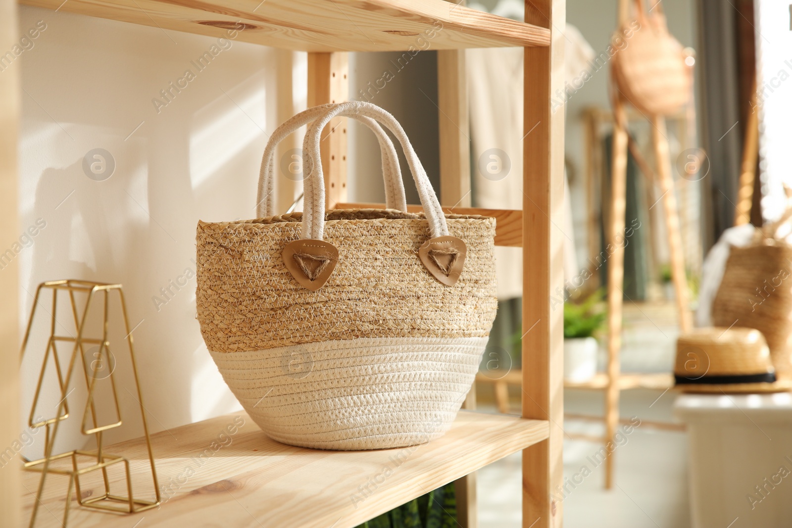 Photo of Stylish woman's bag on shelf in boutique