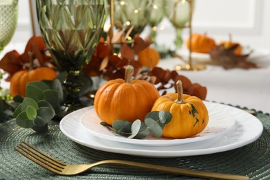 Photo of Beautiful autumn table setting. Plates, cutlery, glasses, pumpkins and floral decor, closeup