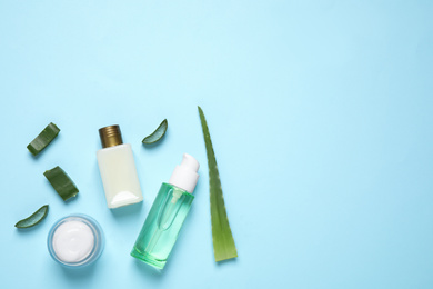 Photo of Flat lay composition with aloe vera and cosmetic products on light blue background. Space for text