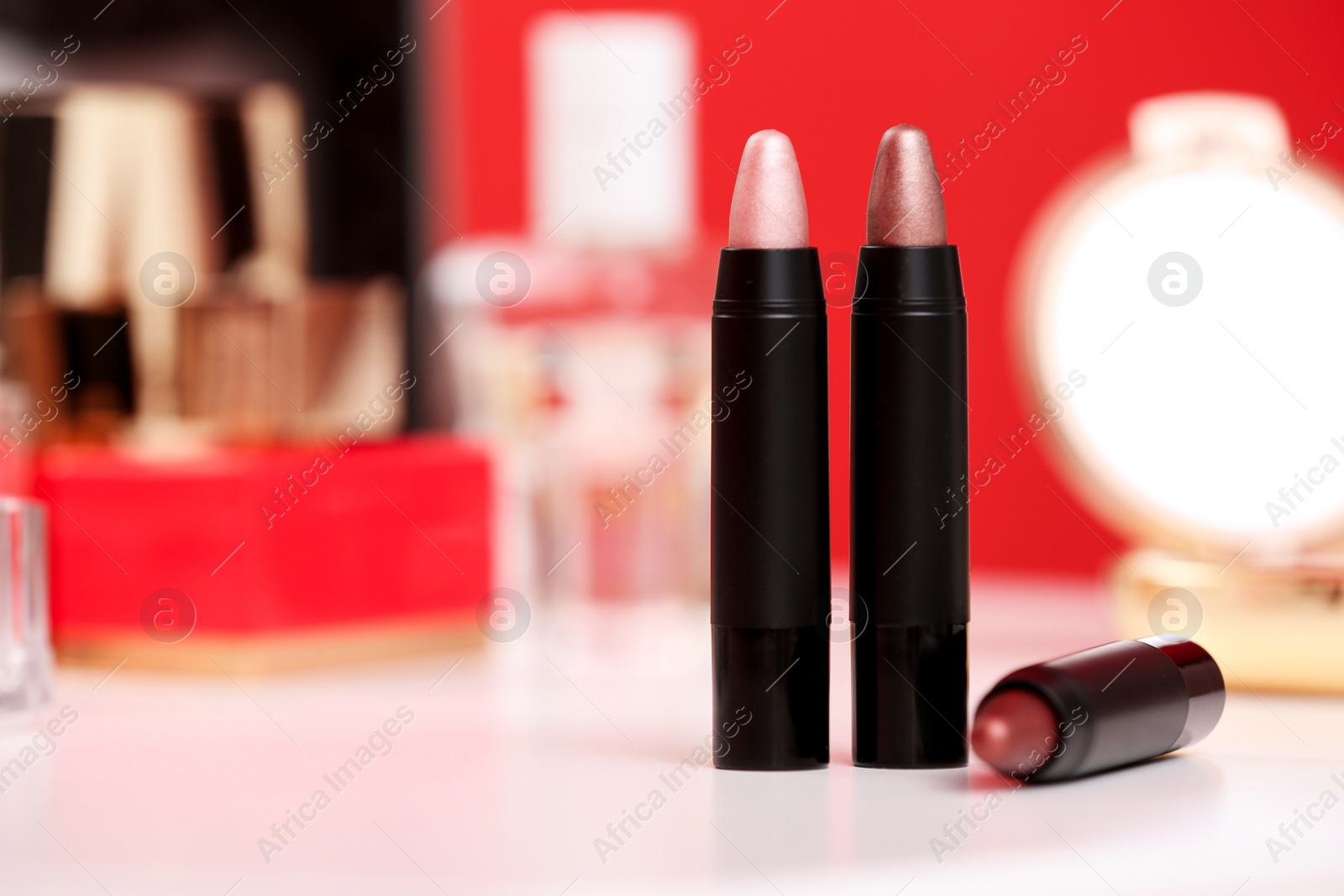 Photo of Different lipsticks on dressing table. Space for text