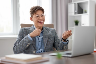 Man using video chat during webinar at wooden table in office