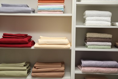 Photo of Different colorful bed linens on display in home textiles store